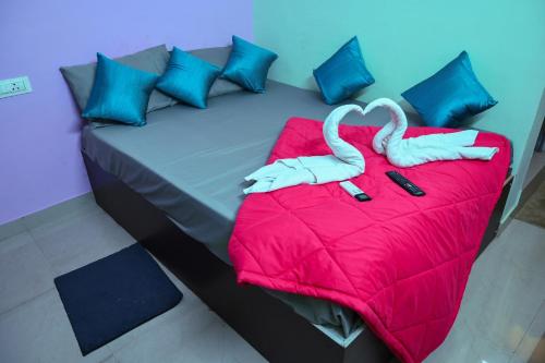 two swans sitting on top of a bed at Royal Rock INN in Harihar