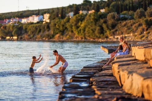 a group of people playing in the water at Apartma VitaMia in Ankaran