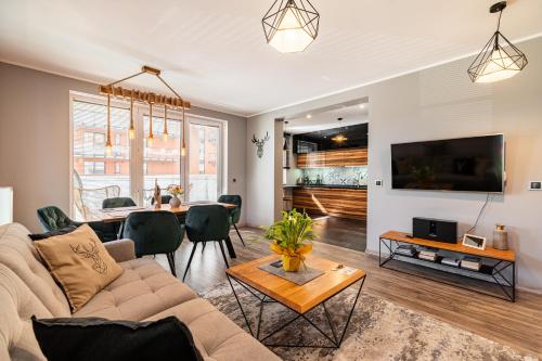 a living room with a couch and a table at LIKE APARTMENT in Kołobrzeg
