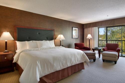 a hotel room with a large bed and a balcony at Maverick Hotel and Casino by Red Lion Hotels in Elko