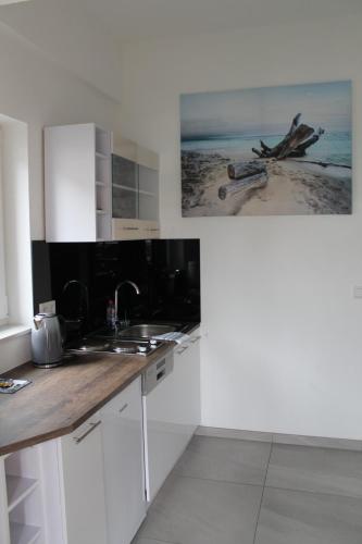 a kitchen with a sink and a counter top at Sleep & Go Motel in Unterbalbach