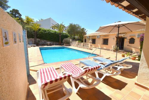a swimming pool with lounge chairs and an umbrella at Casa Vista Montgo Javea - 5048-3 in Balcon del Mar