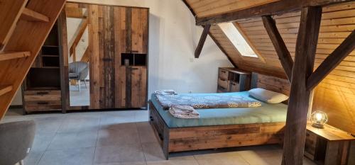 a bedroom with a bed in a room with wooden walls at Apartment da Luiz Salvatore in Wurmlingen