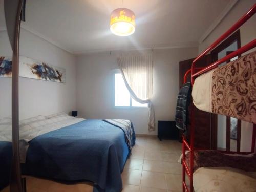 a bedroom with a bed and a bunk bed at La Mata apartment on the first line in La Mata