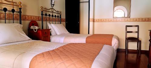 Ένα ή περισσότερα κρεβάτια σε δωμάτιο στο Hostal Colonial Potosi
