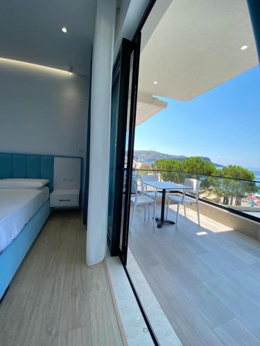 a balcony with a table and a view of the ocean at comfort rooms in Himare