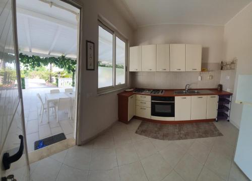 a kitchen with a sink and a stove top oven at SANTA VENERE Apartments "PARCHEGGIO interno MOTO-AUTO" Ricarica auto Elettriche in Tropea