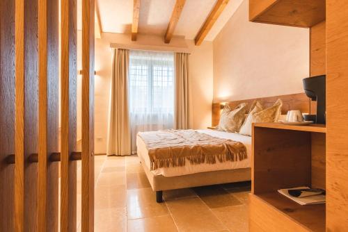 a hotel room with a bed and a window at Borgo Vinceri in Lucera