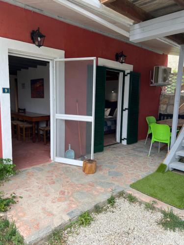 a patio with a sliding glass door and a table at Hamre Apartments (Nicholas) in Agios Georgios Pagon