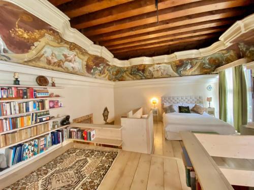 a bedroom with a bed and a book shelf at Venice Palace Luxury Suites in Venice