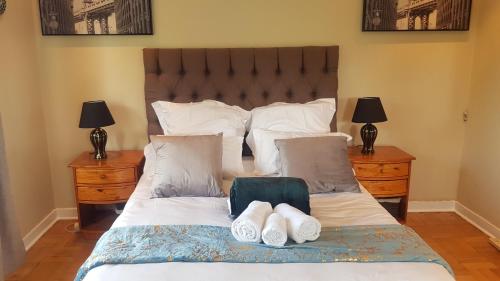 a bedroom with a large bed with two night stands at Multiplex with a view in Durban