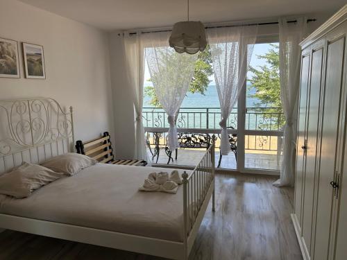 a bedroom with a bed with a view of the ocean at Golden Luxury on the Sand, Villa Maria 2, Chernomoretz, Bulgaria in Chernomorets