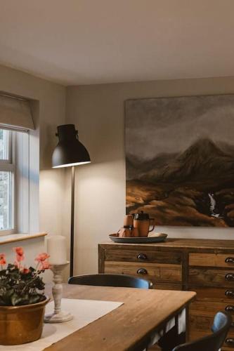 a room with a table and a painting on the wall at Cosy Cottage near Brimham Rocks Yorkshire Dales in Grantley