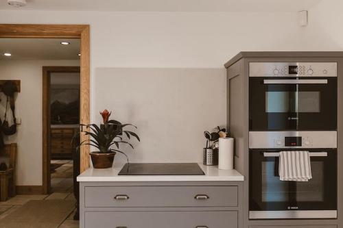 a kitchen with a stove and a stove top oven at Cosy Cottage near Brimham Rocks Yorkshire Dales in Grantley