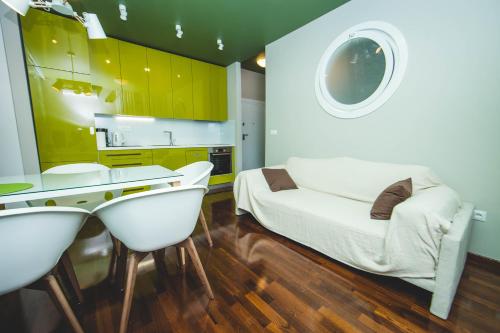 a room with a bed and a table and chairs at Luxury Rooms and Apartment Silente Bacvice in Split