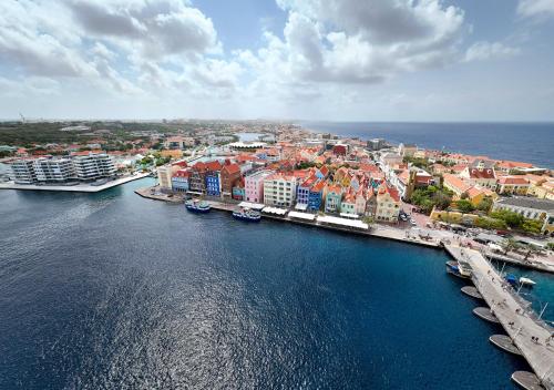 an aerial view of a city and the water at Handelskade Penthouse in Willemstad