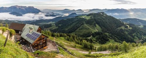a building on a hill with a view of mountains at Alpenresidenz Buchenhöhe in Berchtesgaden