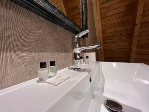a bathroom sink with a faucet on top of it at Qafqaz Suite Paradise Chalet & SPA in Gabala