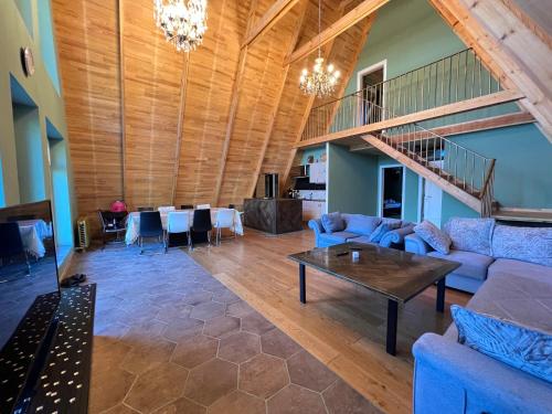 a living room with a couch and a table at Qafqaz Suite Paradise Chalet & SPA in Gabala