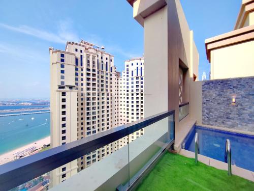a balcony with a view of the ocean and buildings at ELAN RIMAL SADAF Suites in Dubai