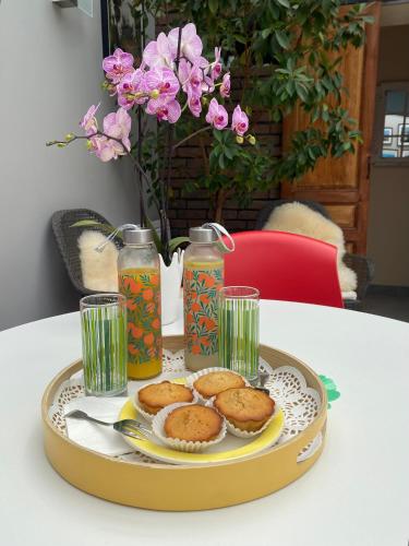 a tray with cookies and drinks on a table at La Maison Angèle in Caisnes