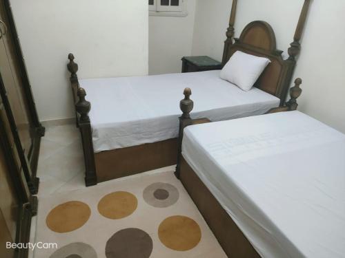 two beds sitting next to each other in a room at Downtown Sea View Suites in Alexandria