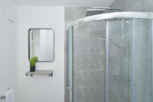 a bathroom with a shower and a mirror at Sapphire Apartments by YourStays - Luxury 2 Bedroom Apartments in Crewe in Crewe