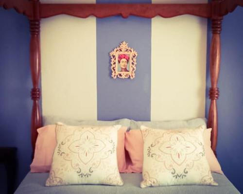 a bedroom with a bed with a canopy with pillows at Romantic Vintage Cottage, Views across vineyards. in Currieʼs Camp