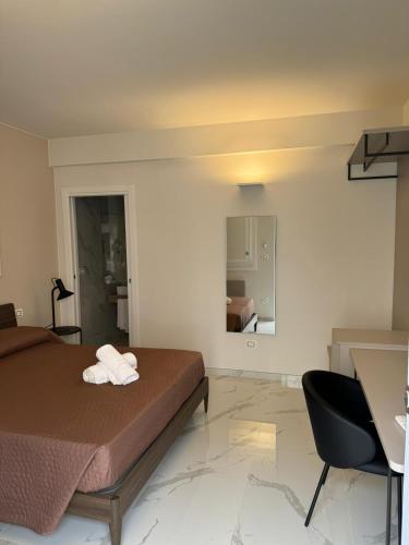 a bedroom with a bed and a desk and a chair at CIVICO 8 in Scalea