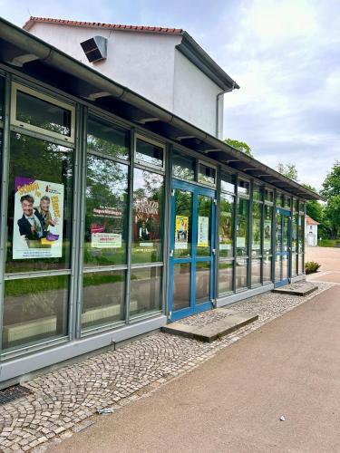 a building with large windows with signs in it at Ferienwohnung HAPPYHOME Bahnhofnah gemütlich familiär in Arnstadt
