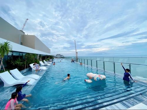 a pool on a cruise ship with people in the water at The Sóng Vũng Tàu Homestay - Suri's Apartment in Vung Tau