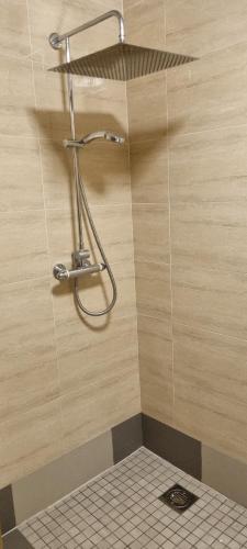 a shower in a bathroom with a tiled wall at Smart Large Room Idealy Located near Doncaster - Rotherham -Sheffield in Rotherham