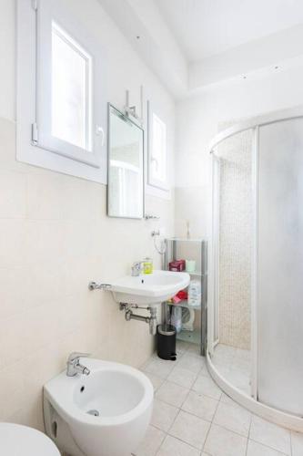 a bathroom with a sink and a toilet and a shower at 200m from the sea, beach place included in Lido di Jesolo