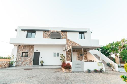 a white house with a driveway at Aurora apartments Room 1 in Marmari