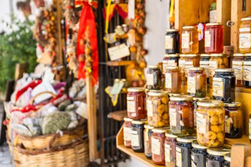 a store filled with jars of food and vegetables at Ινω Superior Suite 1856 Makrinitsa Pelion in Makrinitsa