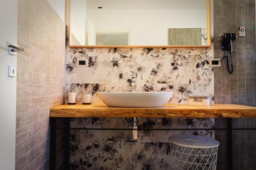 a bathroom with a sink and a mirror at Sunrise Luxury Apartments in Cassibile