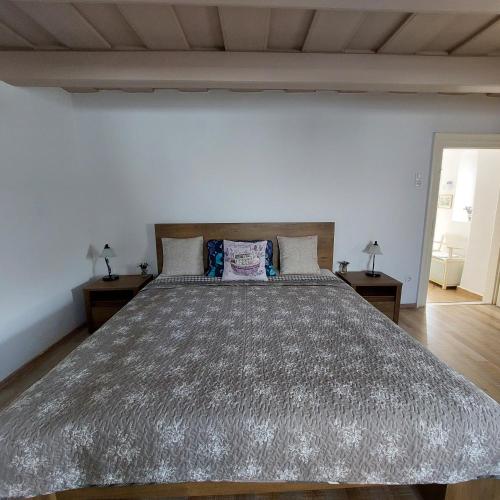 a bedroom with a large bed and two night stands at Fehér szeder in Csopak