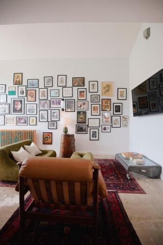 a living room with a couch and a wall of pictures at Molly's Cabin, Countryside Stay in Sutton Bonington