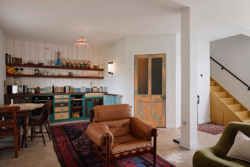 a living room with a chair and a table at Molly's Cabin, Countryside Stay in Sutton Bonington