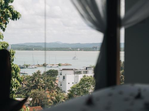 a view of the water from a hotel window at The Nine Mirissa in Mirissa