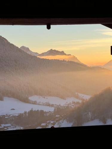 a view from a window of a foggy valley with mountains at Chalet Altitude - Vue panoramique - 8 pers in Bernex