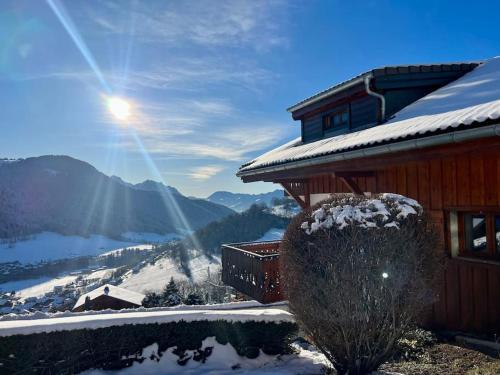 a house with snow on it on a snowy mountain at Chalet Altitude - Vue panoramique - 8 pers in Bernex