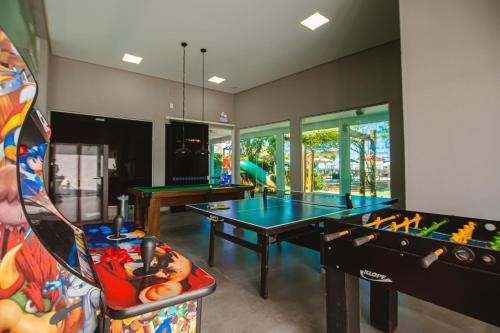 a room with two ping pong tables in it at Hotel VillaReal Guaratuba - Caieiras in Guaratuba