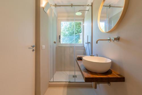 a bathroom with a sink and a mirror and a shower at Villa Morea & Rooms in Procida in Procida