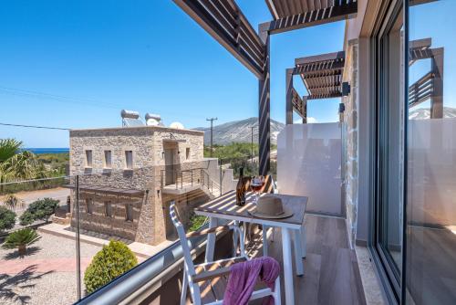 a room with a balcony with a table and chairs at Xasteria in Elafonisi