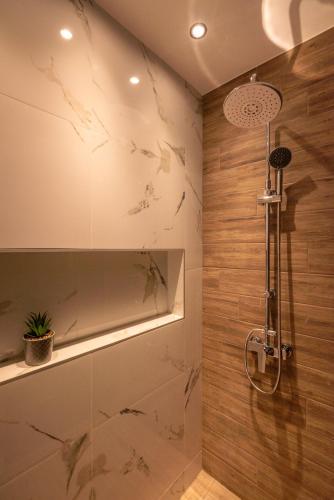 a bathroom with a shower with marble walls at Xasteria in Elafonisi