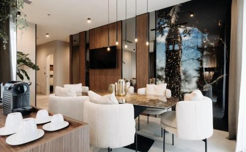 a dining room with a table and white chairs at Hotel Fanat in Split