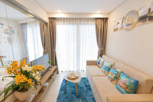 a living room with a couch and a table at The Sóng Vũng Tàu Homestay - Suri's Apartment in Vung Tau