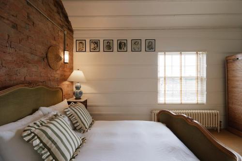 a bedroom with a bed and a brick wall at Beautiful Countryside Farmhouse in Sutton Bonington