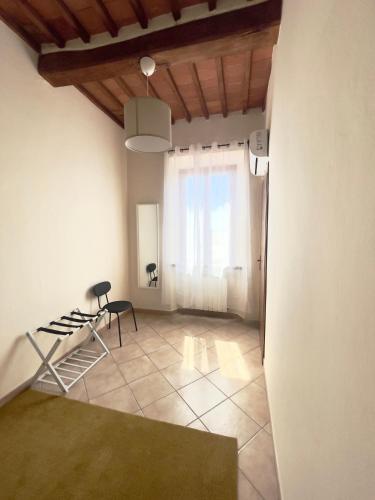 a living room with a table and a chair at Il Borghetto - Fucecchio, Firenze in Fucecchio